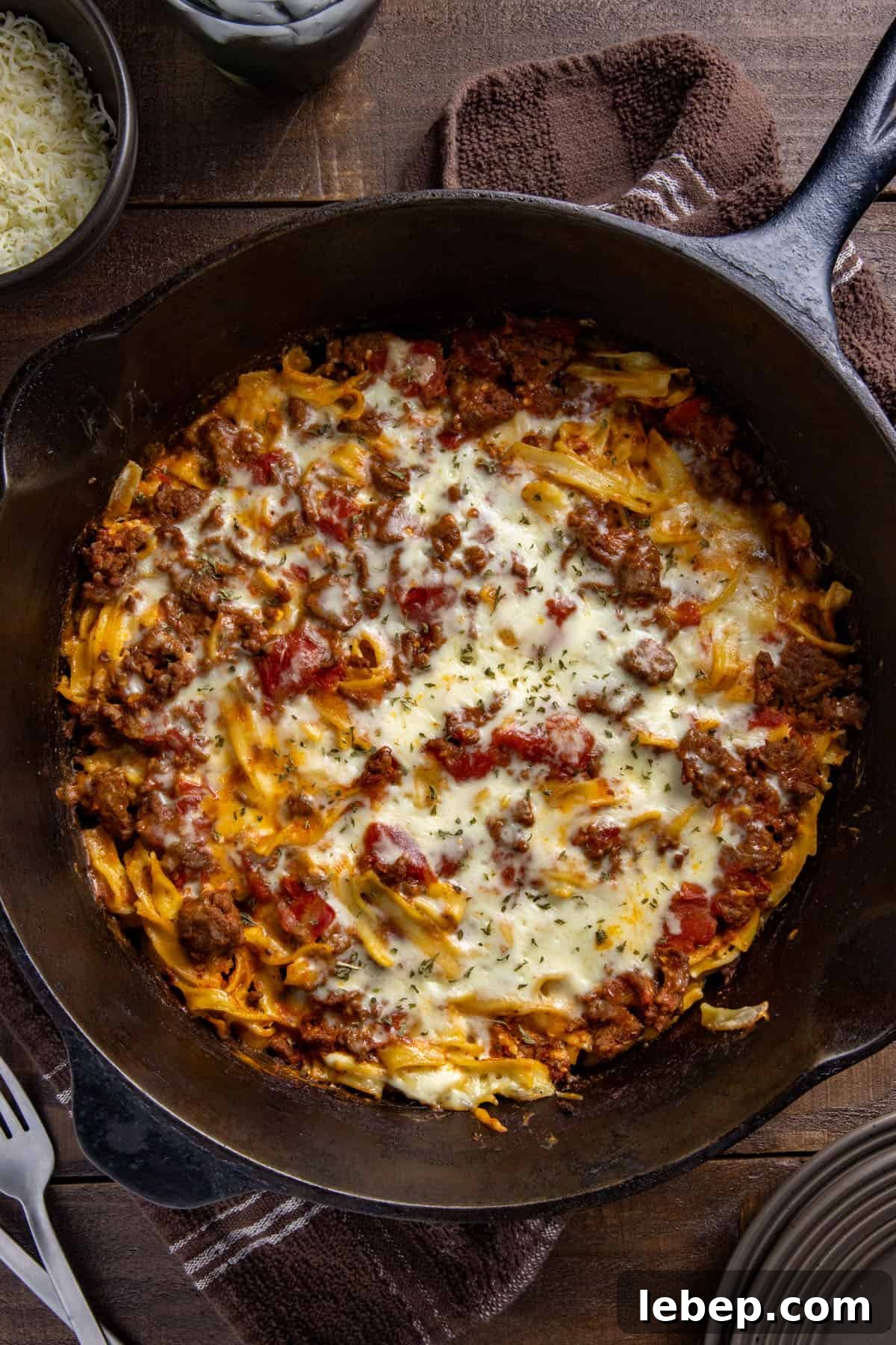 Creamy Sour Cream Noodle Casserole with Cheese and Herbs 2 Baked beef and noodle casserole in a cast iron skillet.
