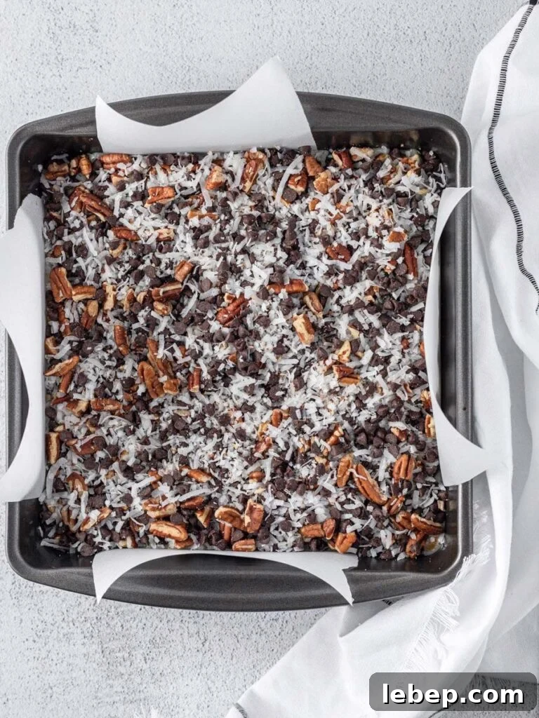 Coconut Magic Bars Recipe: Chewy Coconut Carmel Bars 5 the bar mixture layered up in a square pan