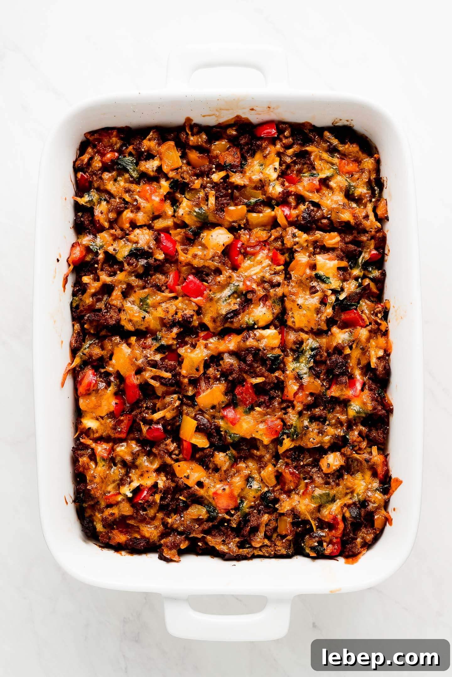 Full dish of Sausage Breakfast Casserole cut in squares.