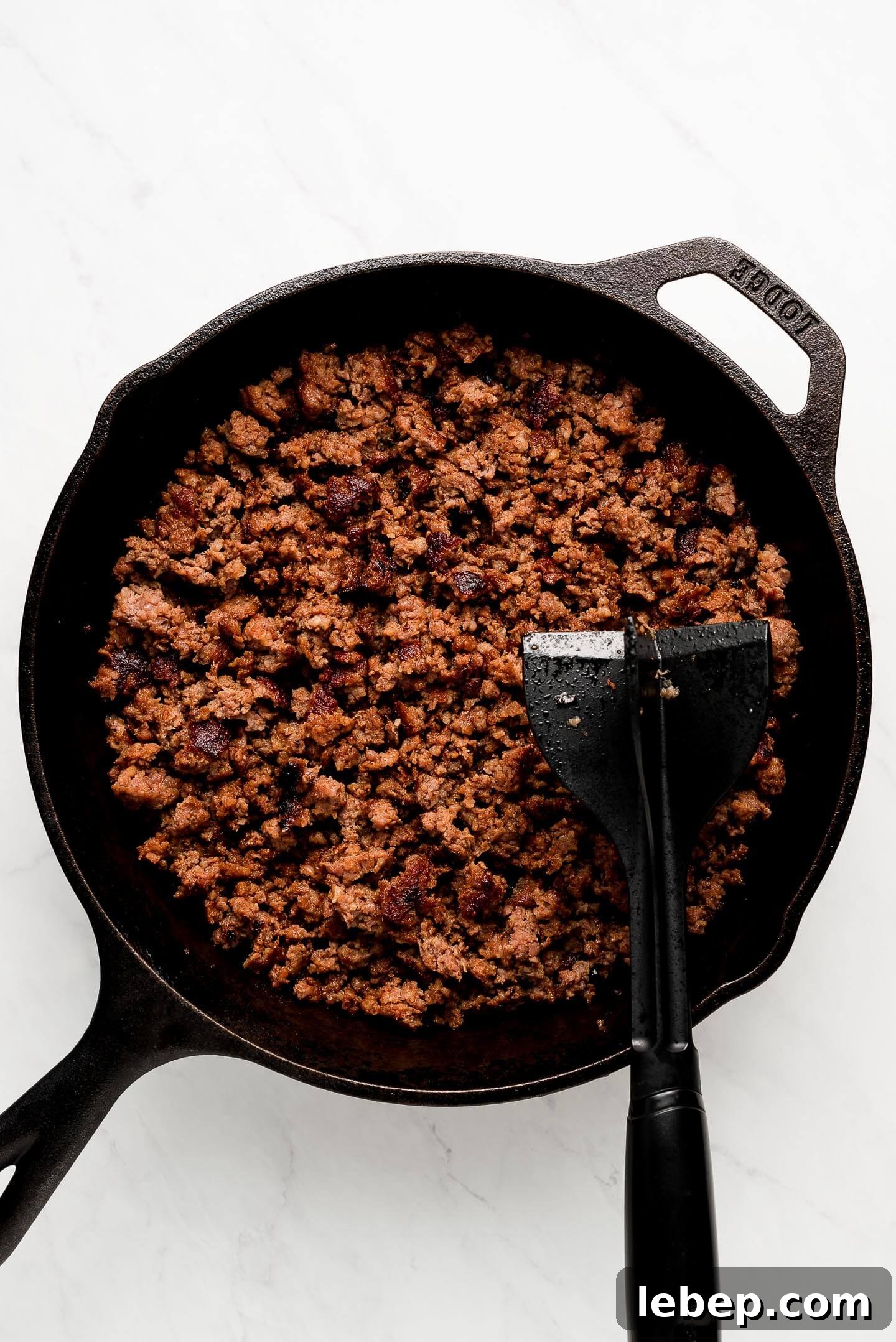 Browned sausage in a cast iron skillet.