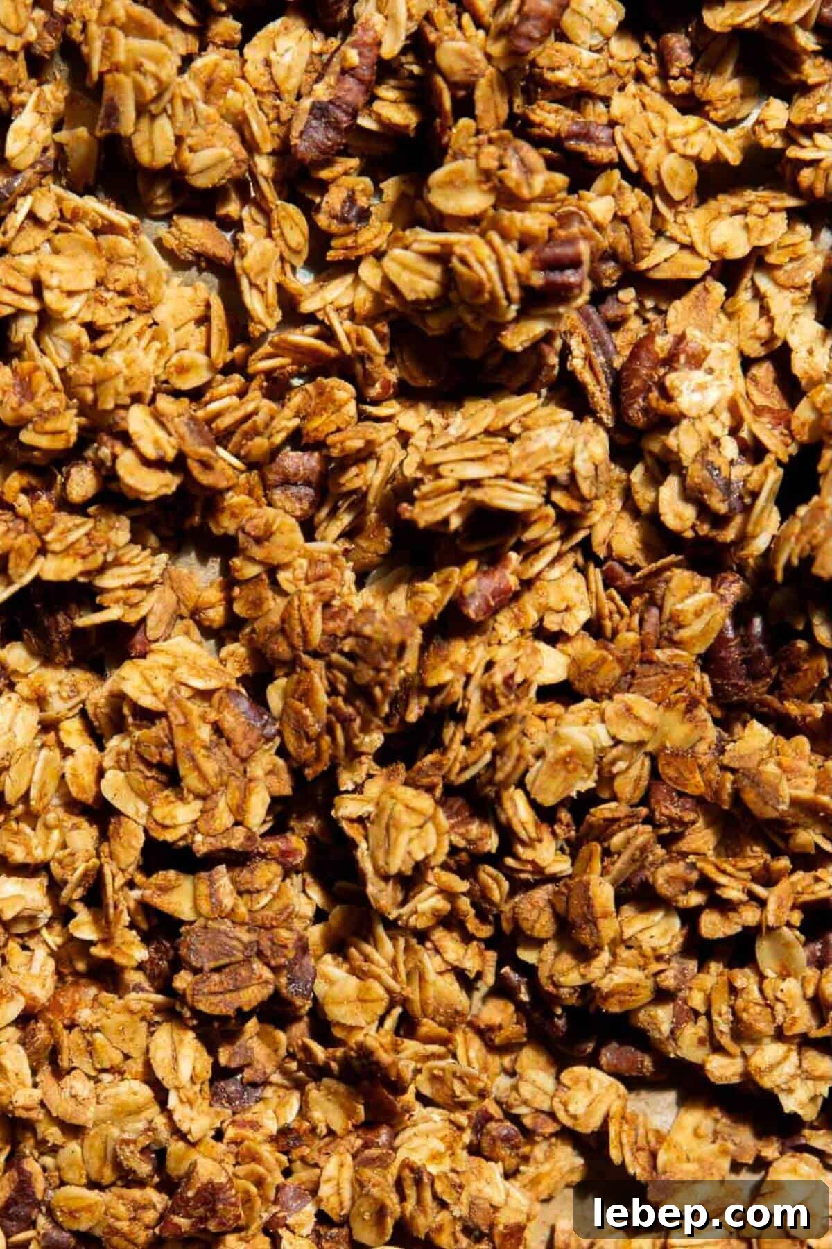 Homemade healthy granola, golden brown and refined sugar-free, made with rolled oats and maple syrup.