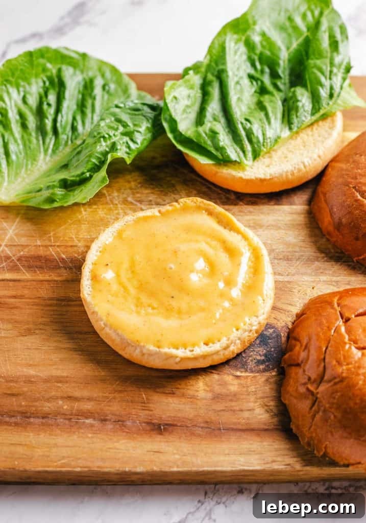 Crispy Fried Chicken Sandwich Recipe with Tangy Slaw 11 Honey mustard sauce spread on a bun.