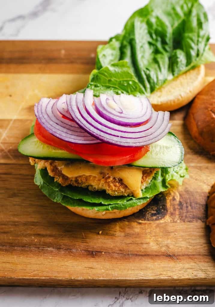 Crispy Fried Chicken Sandwich Recipe with Tangy Slaw 15 Toppings added to the chicken sandwich.