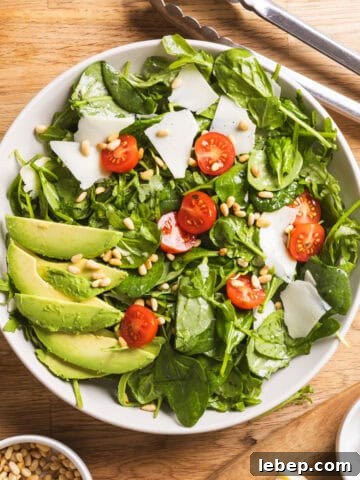 A serving bowl of spinach and arugula salad