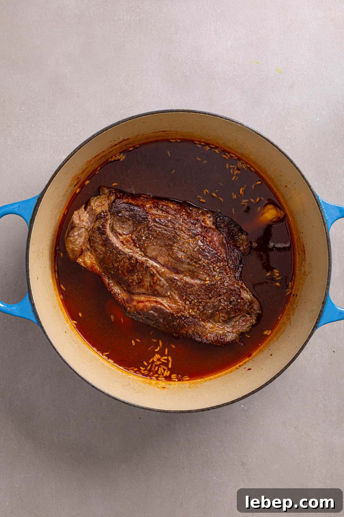 Citrus-Soy Braised Chuck Roast Recipe: Tender, Flavorful Pot Roast 5 A Dutch oven with a browned chuck roast and braising liquid.