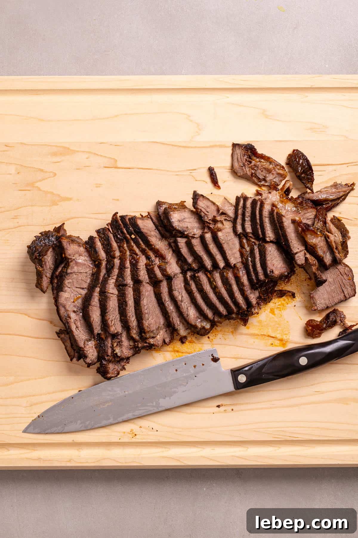 Citrus-Soy Braised Chuck Roast Recipe: Tender, Flavorful Pot Roast 7 Braised chuck roast on a cutting board thinly sliced.