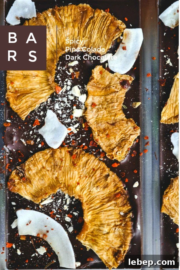 Spicy Pina Colada Dark Chocolate Bar with coconut rum-soaked dehydrated and freeze-dried pineapple, shaved coconut and Aleppo flakes on dark chocolate.