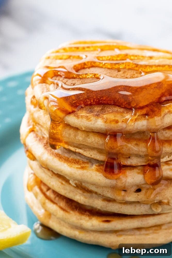 Whole Wheat Pancakes Stack of Whole Wheat Pancakes drizzled with Maple Syrup.