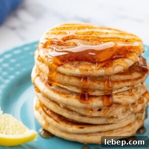 Fluffy Whole Wheat Pancakes with Maple Syrup Recipe 3 Stack of whole wheat pancakes on plute plate topped with syrup