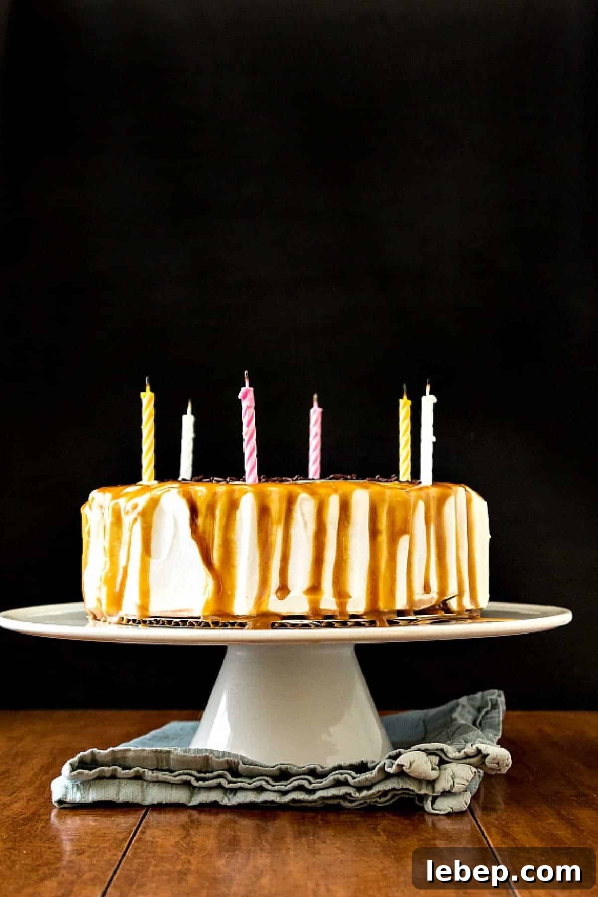 Birthday Ice Cream Cake made with store-bought ice cream, caramel whipped cream, sprinkles and butterscotch sauce. An ice cream cake with birthday candles in it.