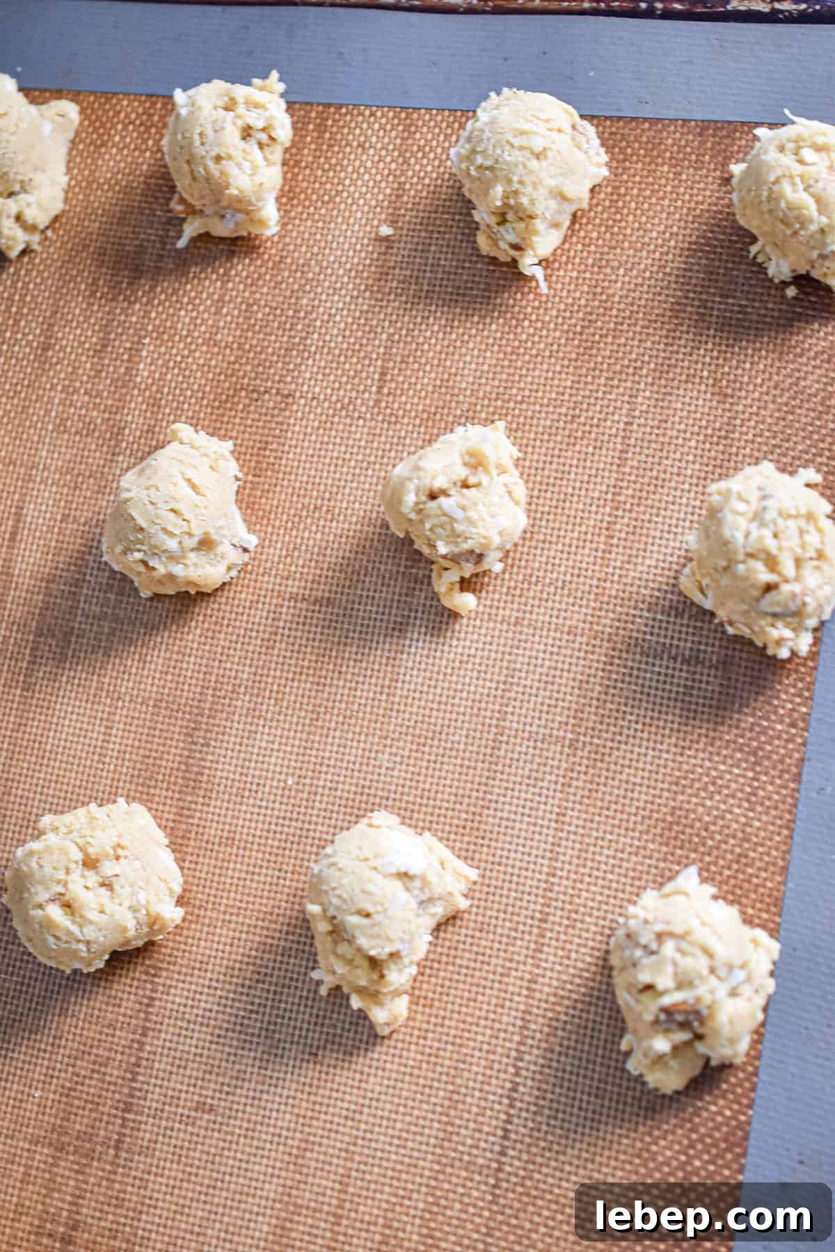 Chewy Coconut Pecan Cookies Recipe — Crispy Edges & Gooey Center 9 The dough balls are on a baking sheet.