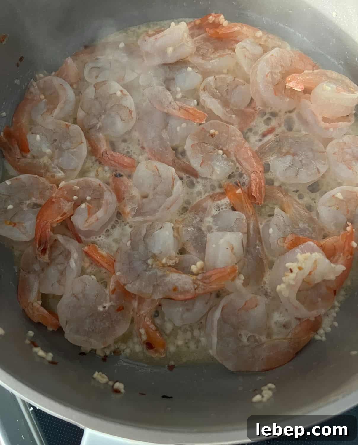 One-Pot Lemon Garlic Shrimp Pasta Recipe 5 Shrimp with seasonings cooking in a skillet.