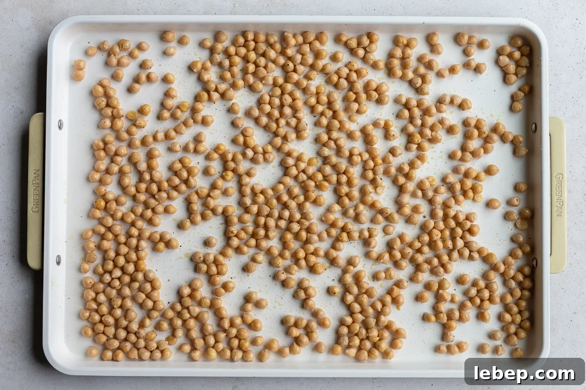 chickpeas on a baking tray to be roasted