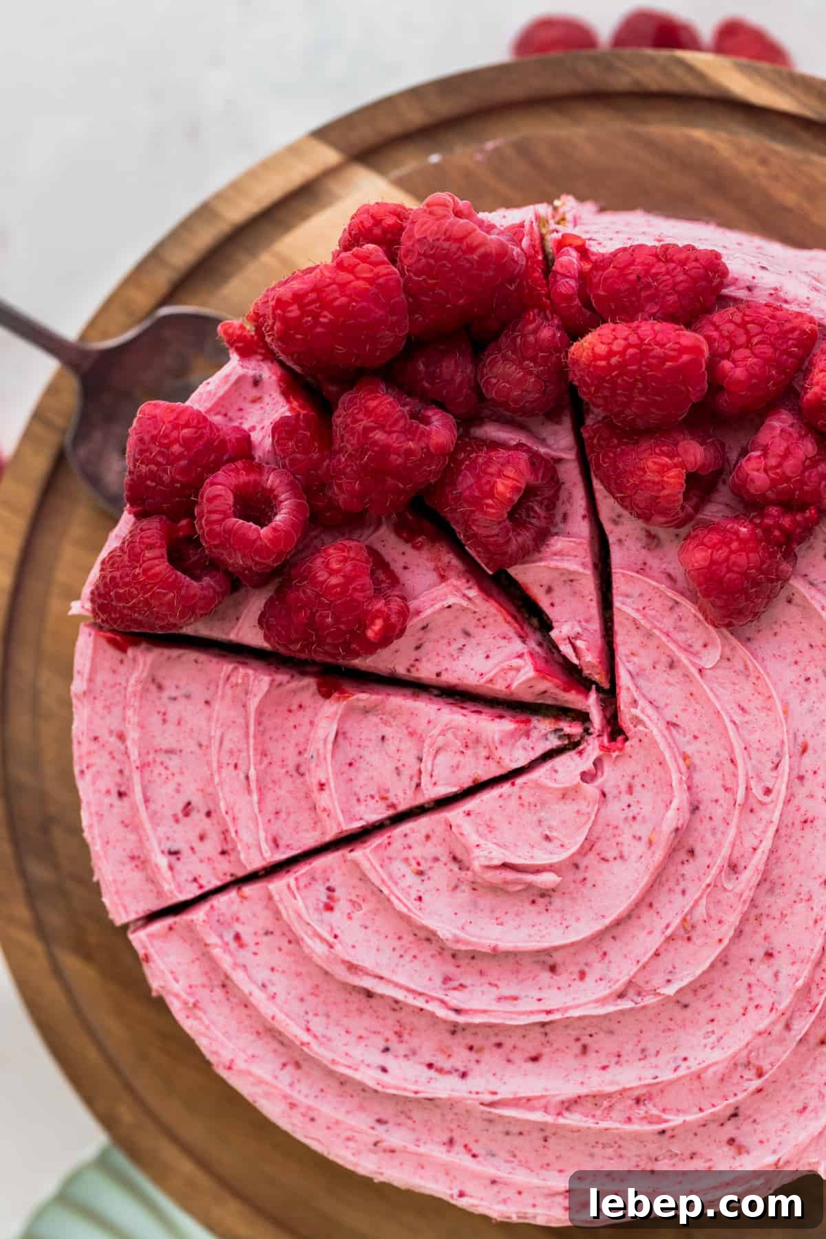 Top view of the cake with three slices being cut out.