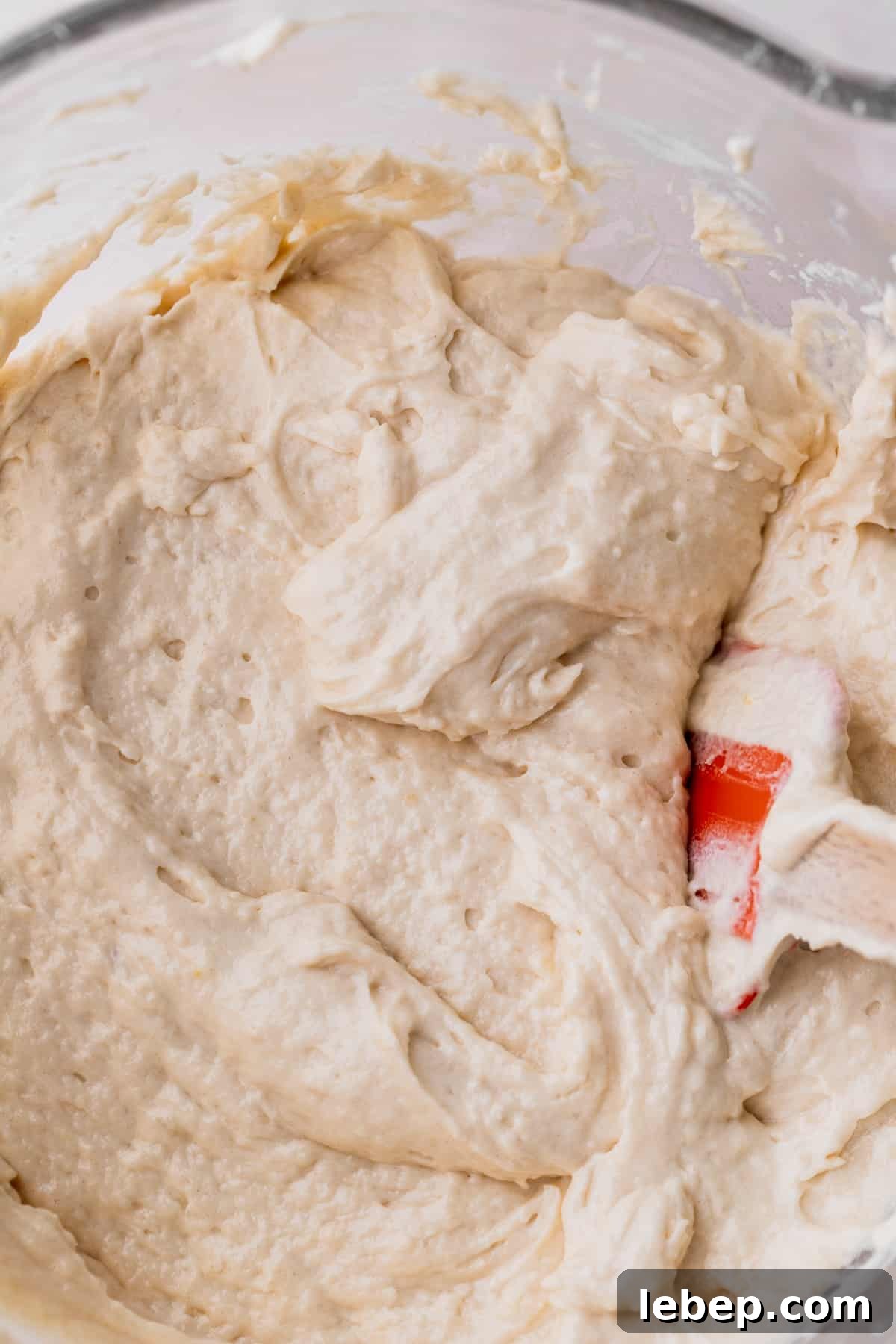 Vanilla cake batter in a glass bowl.