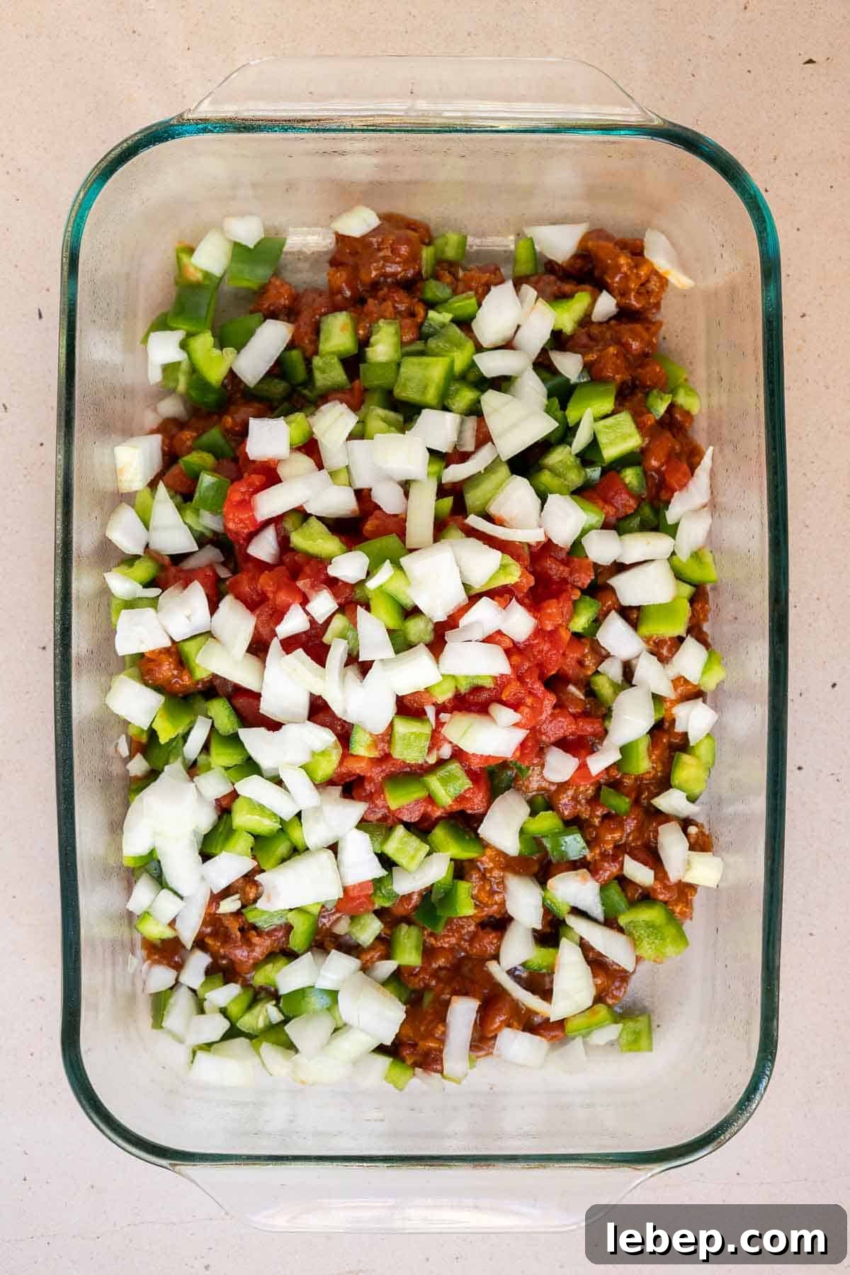 Canned Chili Cornbread Casserole Recipe for Quick Weeknight Dinner 5 The canned chili and diced veggies are added directly to a 9 by 13 inch baking dish.
