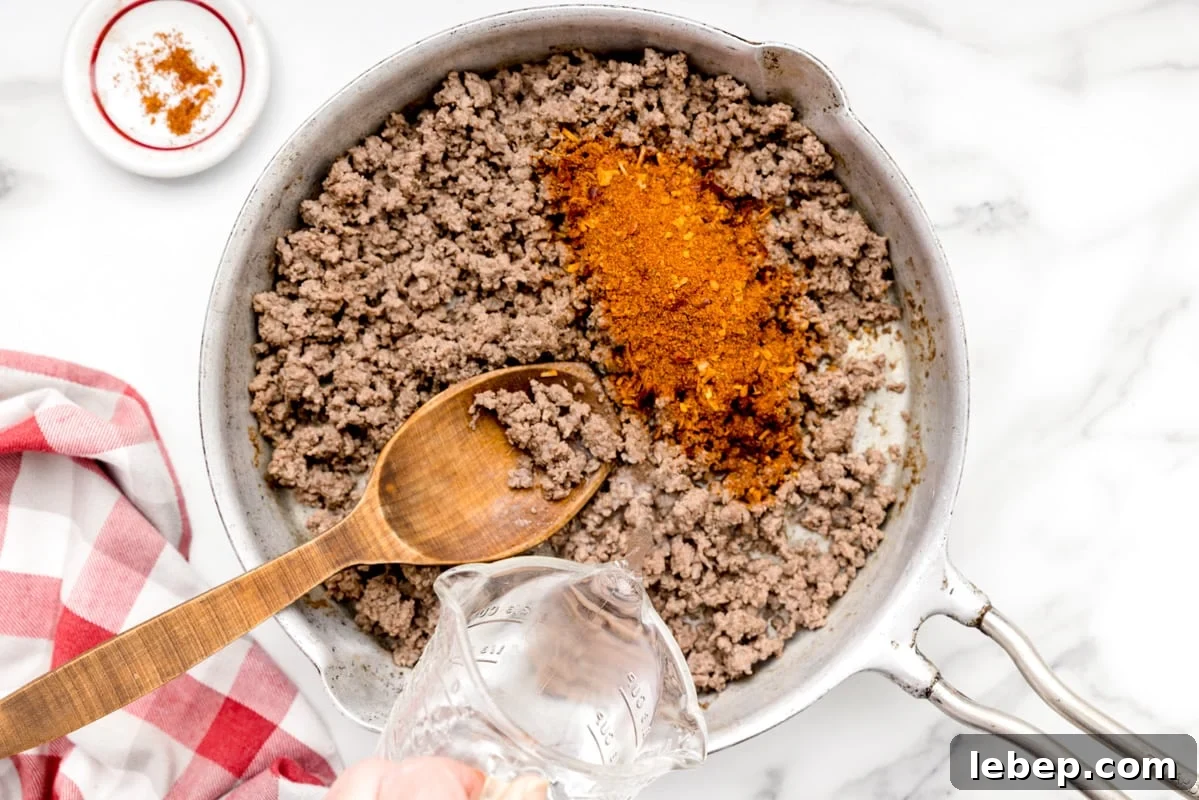 Walking Tacos: Portable Taco Cups for Parties and Snacks 2 Taco seasoned ground beef in a skillet.