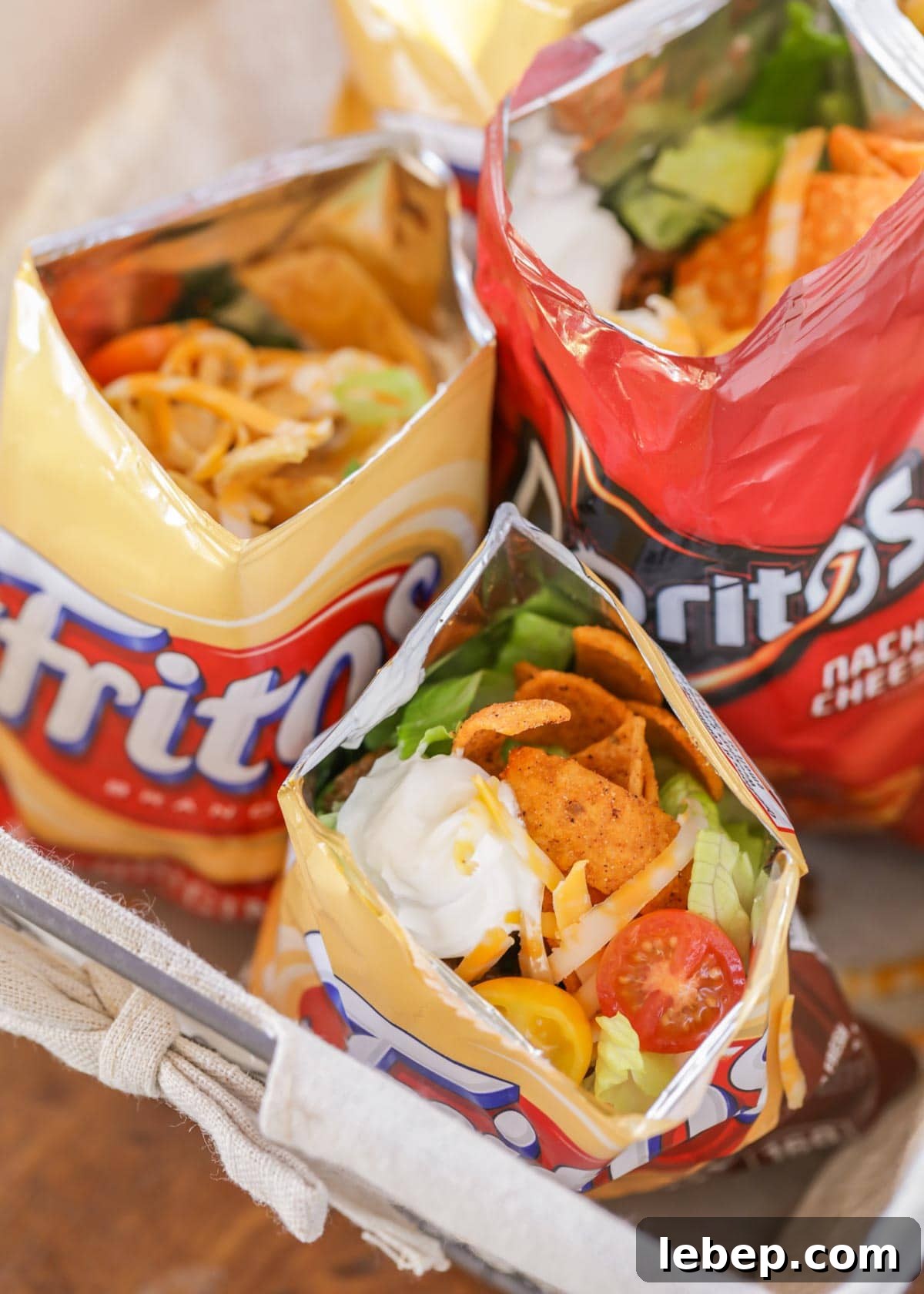 Walking tacos are an easy grab-and-go meal that is full of flavor! They are no mess, easy to make, and perfect for large gatherings!! Walking tacos recipe in small chip bags.