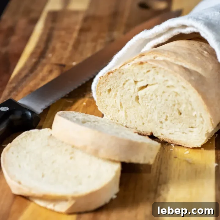 A loaf of Italian bread with two slices cut off.