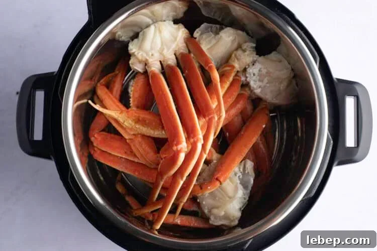 Overhead view of snow crab leg clusters in Instant Pot.
