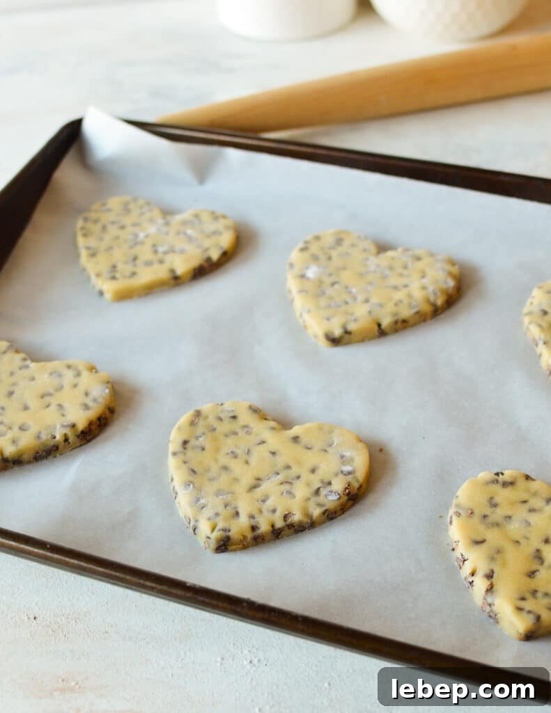 Heart-Shaped Chocolate Chip Cookies Recipe for Valentine Treats 8 heart cookies on a sheet pan