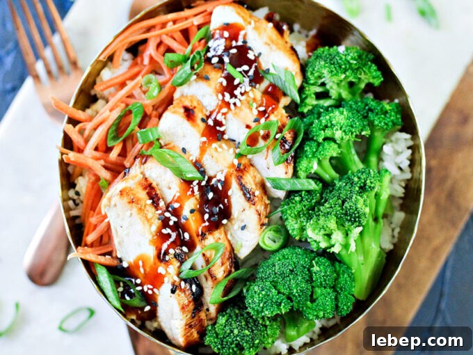 General Tso Grilled Chicken Rice Bowls — Sweet-Spicy Asian Flavor 2 grilled chicken, broccoli and carrots in a bowl with General Tso's chicken sauce.