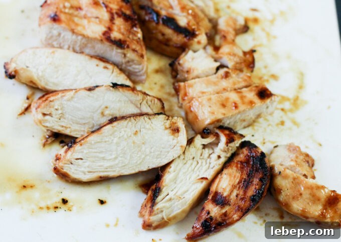 General Tso Grilled Chicken Rice Bowls — Sweet-Spicy Asian Flavor 6 sliced grilled chicken on a white plate.