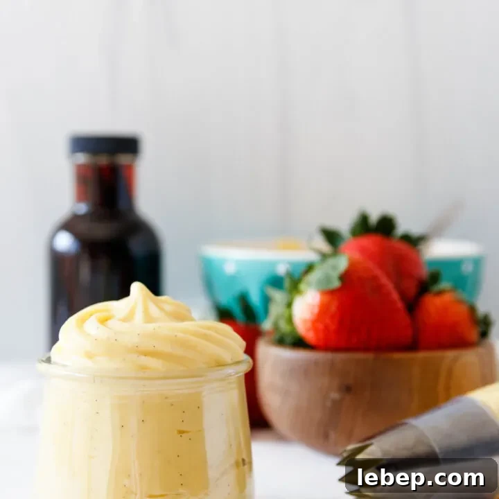 pastry cream piped into a small jar and up into a small point to show consistency
