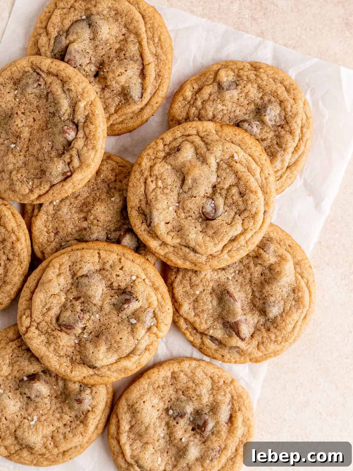 Chewy Malted Milk Chocolate Chip Cookie Recipe 2 Chewy malted chocolate chip cookies on parchment paper.