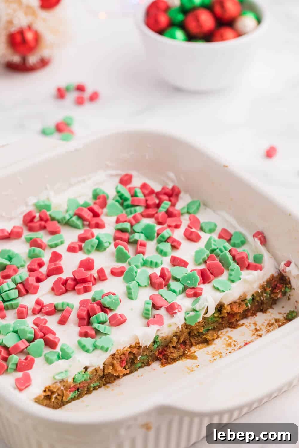The recipe in a baking pan with some bars cut out of it.