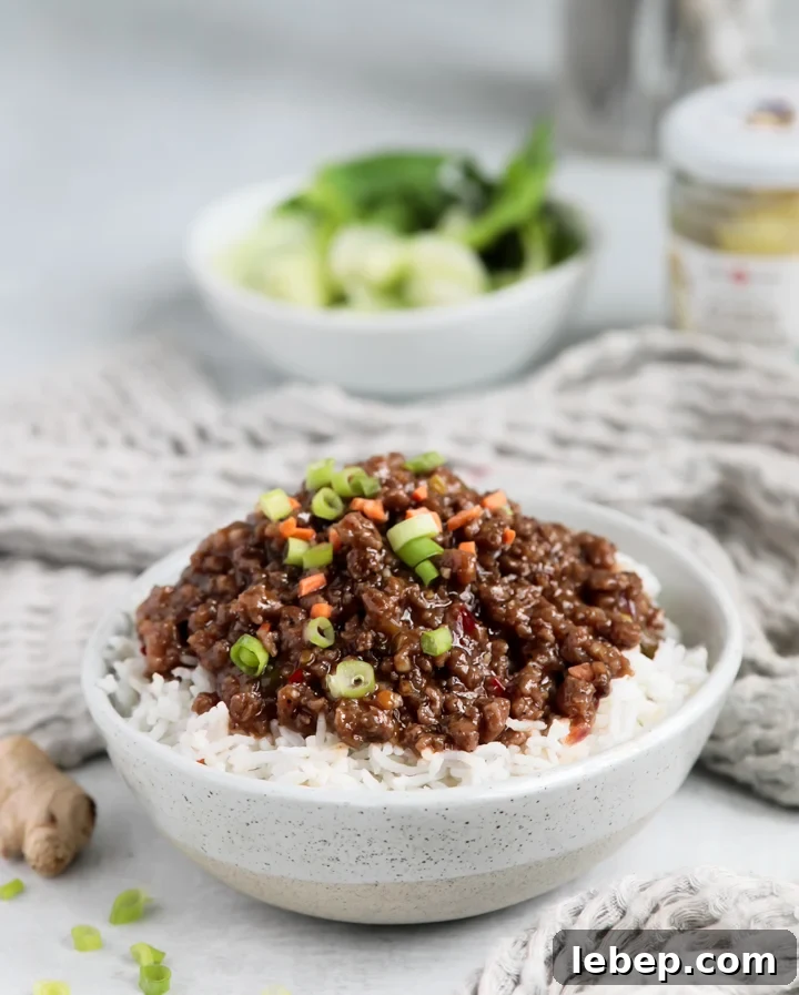 15-Minute Sweet Chili Ground Beef Stir-Fry Recipe 2 A bowl of Korean beef bowl inspired sweet chili ground beef topped with green onions