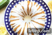 stunning lemon zucchini bundt cake served on a beautiful polish pottery plate