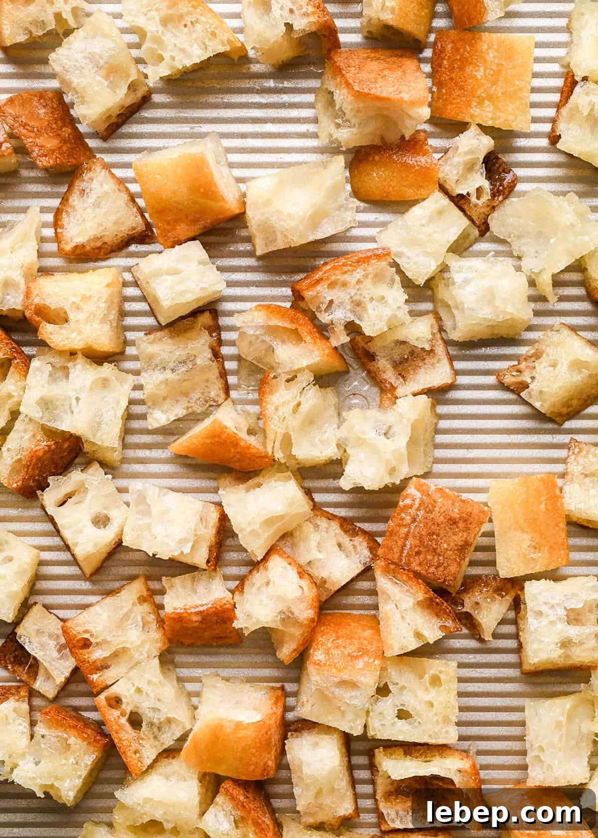 How to Make Croutons - bread spread onto a baking sheet before baking