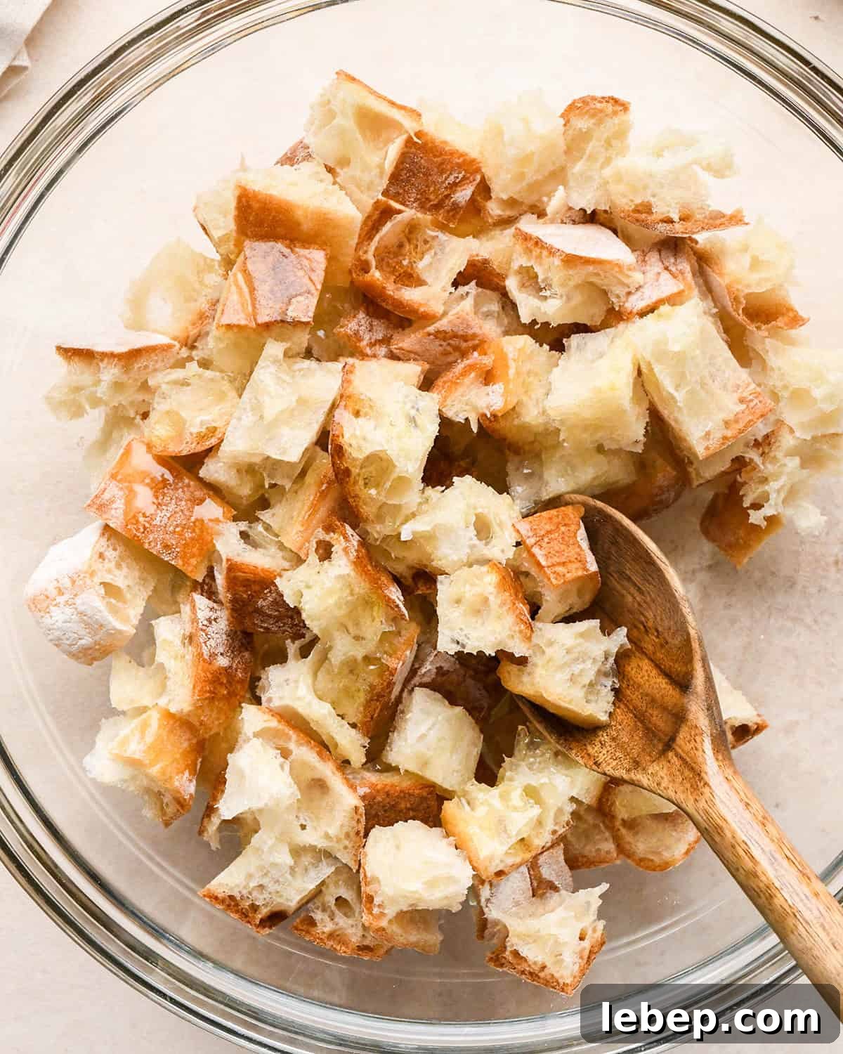 How to Make Croutons - stirring olive oil into bread cubes
