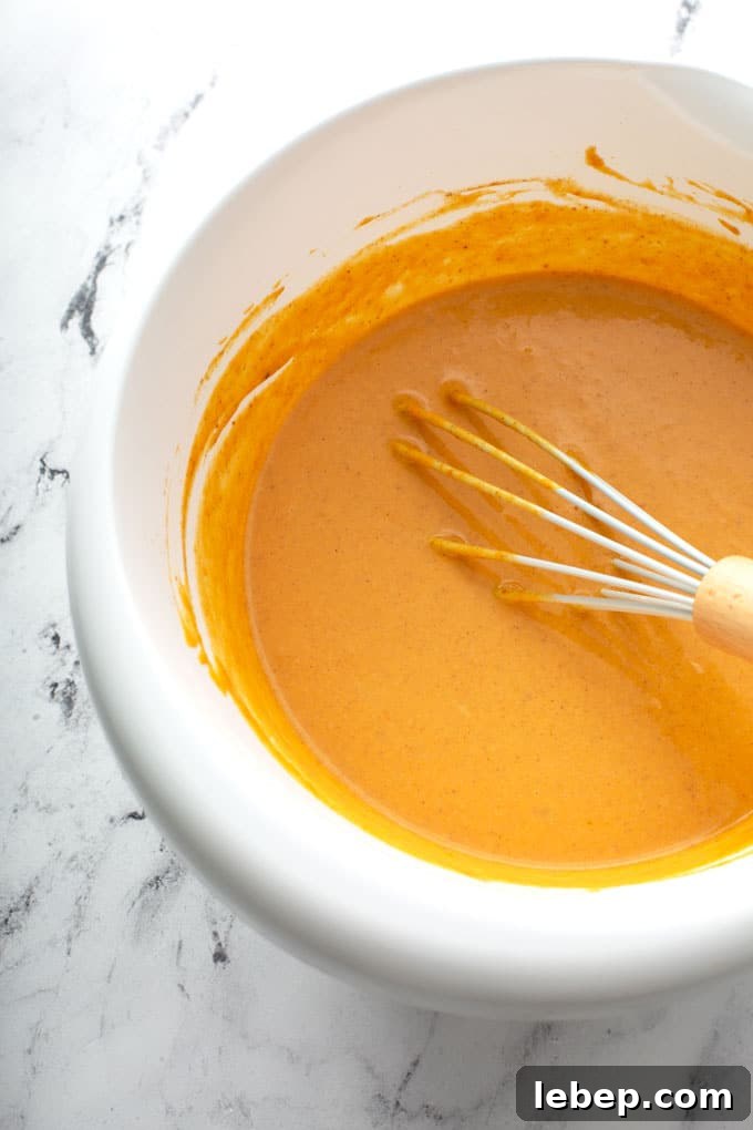 Smooth pumpkin pie filling in a white bowl.