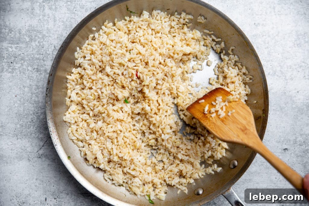 Brown rice cooking in a large skillet for the fried rice. 