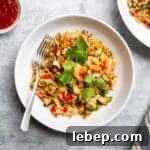 Salmon fried rice in a bowl with a fork.