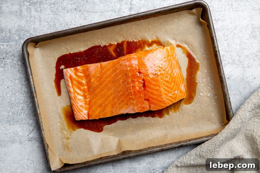 Salmon on a baking sheet drizzled with tamari.