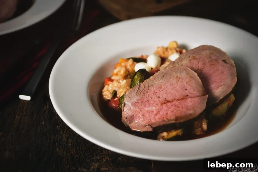 Tender Melt-in-Your-Mouth Eye of Round Roast Recipe 8 Two slices of eye of round roast over a fall roasted veggie risotto