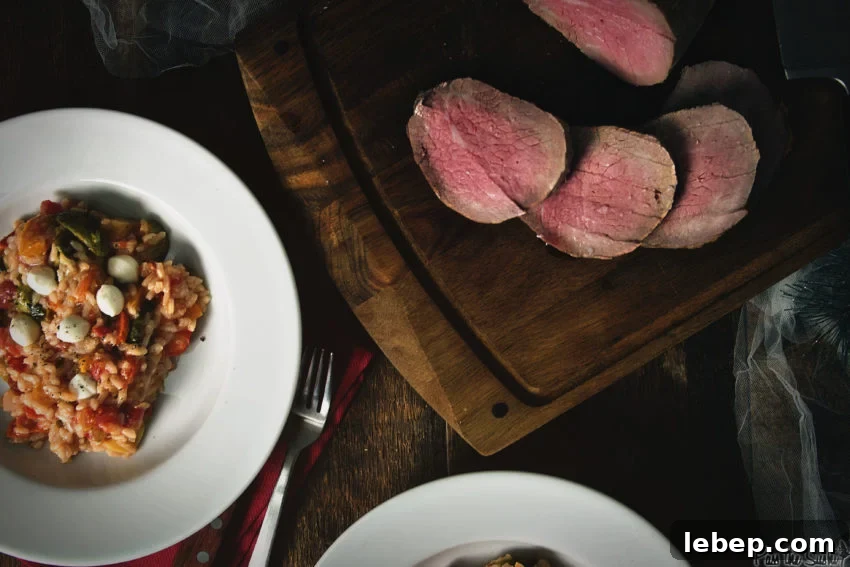 Tender Melt-in-Your-Mouth Eye of Round Roast Recipe 10 Slices of eye round roast on a cutting board with dishes filled with fall risotto