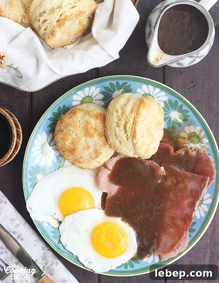 Southern Country Ham with Classic Red-Eye Gravy Recipe 9 plate of sunny side up eggs, biscuits and country ham covered in red eye gravy