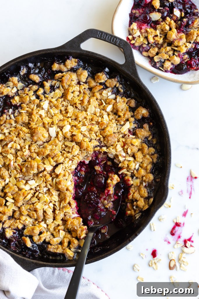Mixed Berry Oat and Almond Crisp Recipe 16 Scooping Mixed Berry Oat Almond Crisp