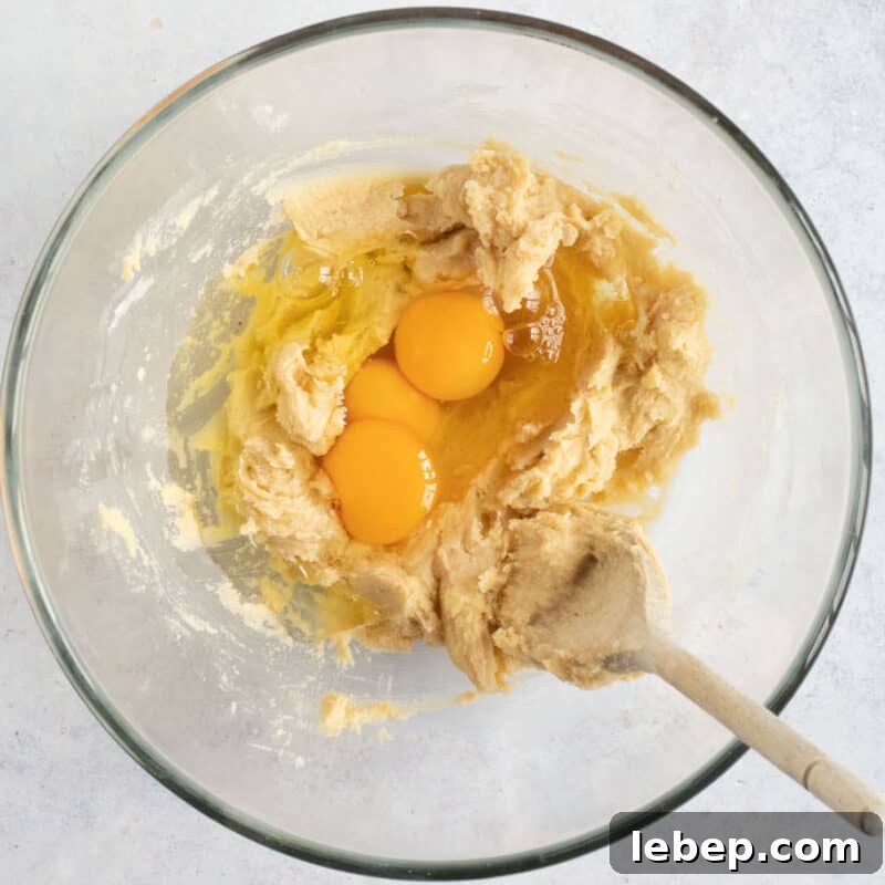 Air Fryer Banana Bread Recipe: Moist, Quick Loaf in 30 Minutes 5 Eggs with butter and sugar in a bowl.