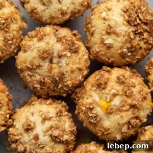 Almond Streusel Peach Muffins. Vanilla muffins mixed with fresh peaches and topped with almond streusel crumble.