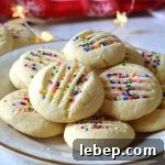 Buttery Whipped Shortbread Cookies Recipe for Light, Melt‑in‑Your‑Mouth Treats 7 a white plate filled with whipped shortbread cookies