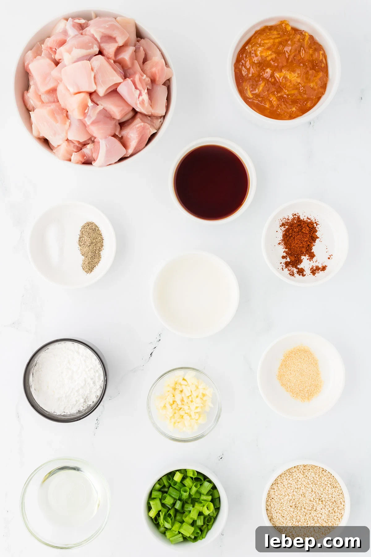 The ingredients for making orange chicken are set out on the counter.