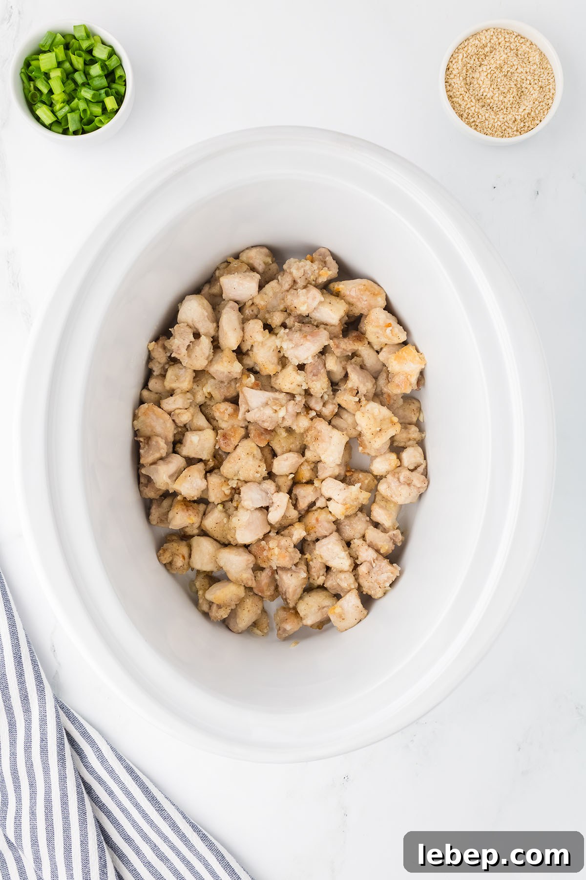 Seared chicken added to slow cooker.