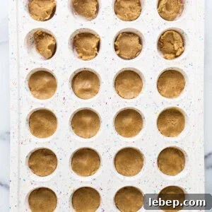 Peanut Butter Twix Cups Recipe — Homemade Candy Bars in Minutes 10 A tray filled with peanut butter cookies.