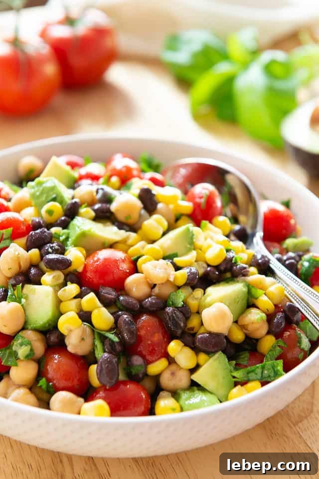 20+ Picnic and Potluck Salads That Stay Fresh and Travel Well 18 Avocado Bean Salad - In White Bowl with Corn and Tomatoes