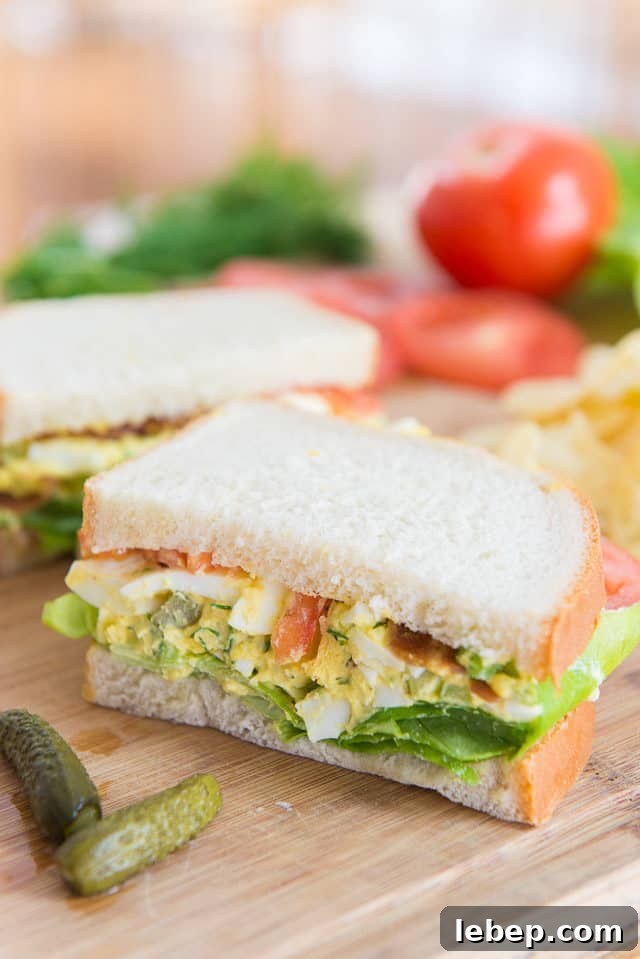 20+ Picnic and Potluck Salads That Stay Fresh and Travel Well 3 Egg Salad Sandwich on a Wooden Board with Pickle